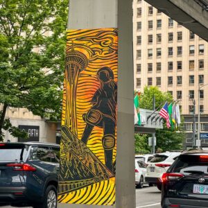 linocut print of girl skateboarding and the Space Needle on monorail column