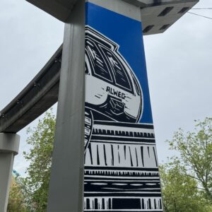 linocut print on monorail column with the front end of the Seattle Center Monorail train