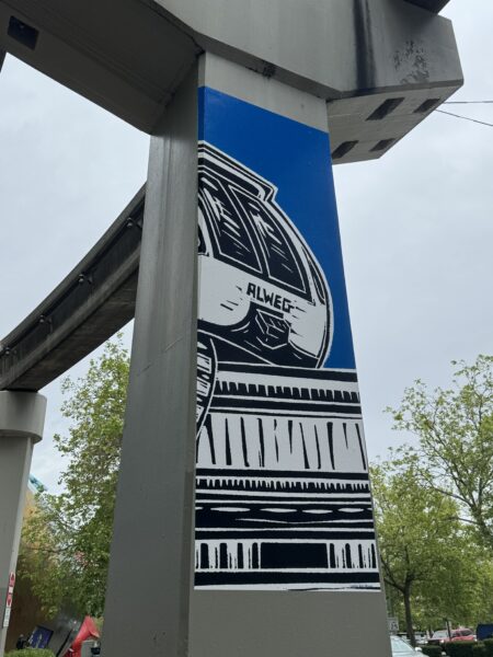 linocut print on monorail column with the front end of the Seattle Center Monorail train